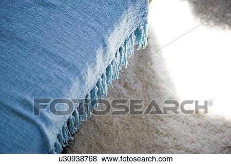 Blue throw blanket with tassels hanging over chair View Large Photo Image Stock Photo - Blue throw blanket with tassels hanging over chair. Fotosearch