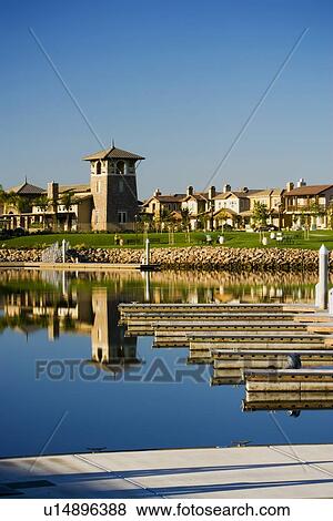 Boat docking area in channel by contemporary housing community View Large Photo Image Stock Photo - Boat docking area in channel by contemporary housing community. Fotosearch