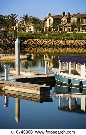Boats docked at housing community View Large Photo Image Stock Image - Boats docked at housing community . Fotosearch