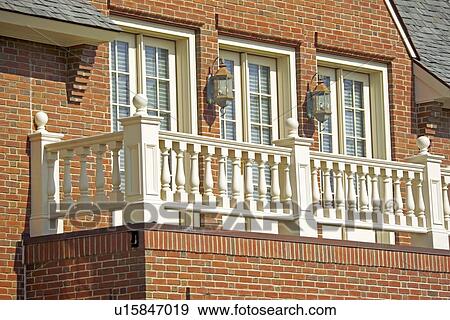 Brick house with balcony and multiple double doors View Large Photo Image Stock Photo - Brick house with balcony and multiple double doors. Fotosearch