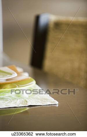 Stock Image - Bright orange and green place setting. Fotosearch