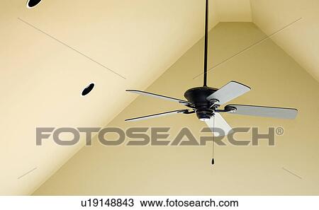 Ceiling fan hanging from pitched ceiling View Large Photo Image Stock Image - Ceiling fan hanging from pitched ceiling. Fotosearch