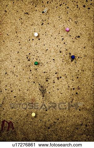 Stock Image - Close up cork bulletin board with push pins. Fotosearch