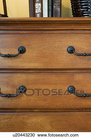 Stock Image - Close up of dresser with books on top. Fotosearch