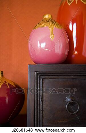 Stock Photo - Collection of decorative vases on top of wooden drawer. Fotosearch