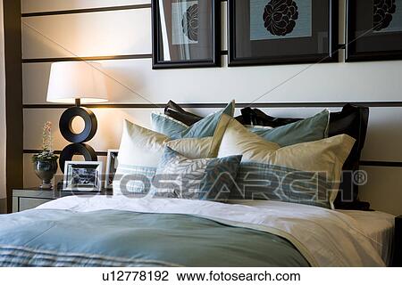 Stock Image - Collection of pillows on bed. Fotosearch