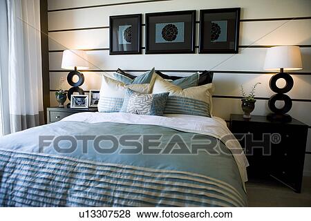 Stock Photo - Collection of pillows on bed. Fotosearch
