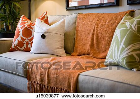 Comfortable Sofa With Orange Throw Blanket And Decorative Pillows Stock Photo Comfortable Sofa With Orange Throw Blanket And Decorative Pillows Stock Photo