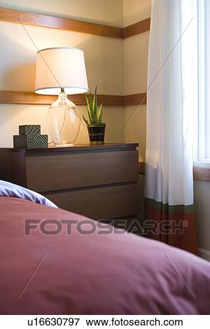 Stock Photo - Contemporary bedside table with lamp. Fotosearch