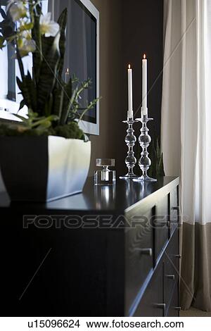 Contemporary dresser with candlesticks and house plant View Large Photo Image Picture - Contemporary dresser with candlesticks and house plant. Fotosearch