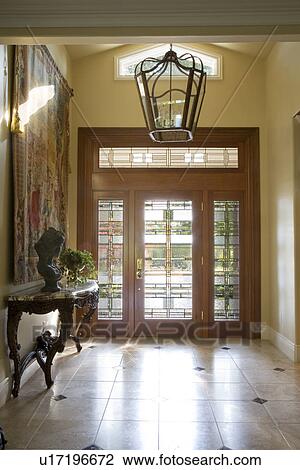Contemporary foyer with glass front door and cathedral ceiling View Large Photo Image Stock Image - Contemporary foyer with glass front door and cathedral ceiling. Fotosearch