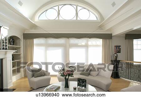 Stock Image - Contemporary living room with geometric windows. Fotosearch