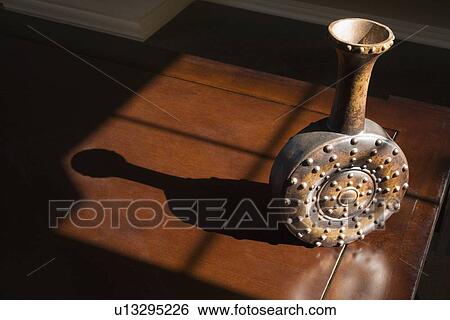 Contemporary vase sitting on wooden table in sunlight View Large Photo Image Stock Photograph - Contemporary vase sitting on wooden table in sunlight. Fotosearch
