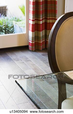Corner of glass dining table and round back chair View Large Photo Image Picture - Corner of glass dining table and round back chair. Fotosearch