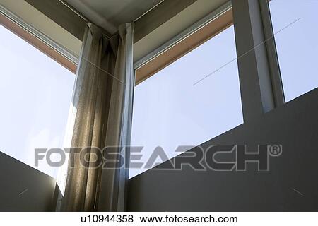 Stock Photo - Corner of loft style condo with high windows. Fotosearch