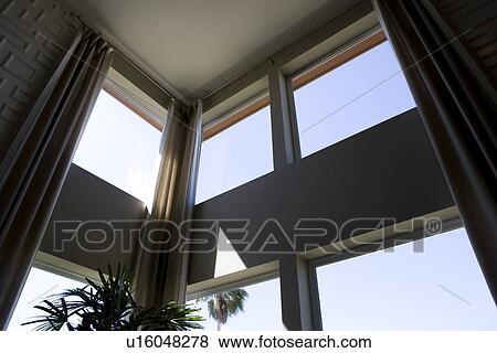 Stock Photo - Corner of loft style condo with high windows. Fotosearch