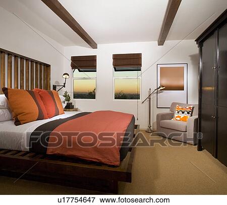 Stock Photo - Cozy Bedroom with Terra Cotta Colored Comforter. Fotosearch