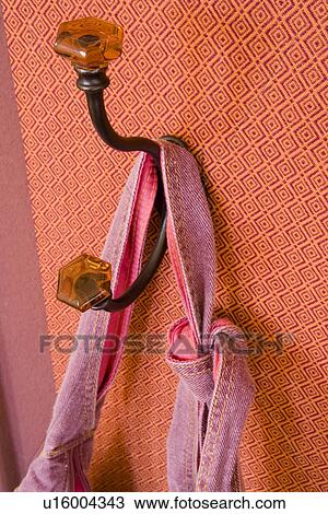 Stock Image - Decorative hook on printed wall paper wall. Fotosearch
