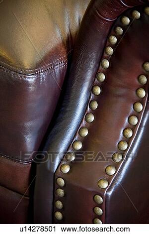 Stock Image - Detail brown leather armchair. Fotosearch