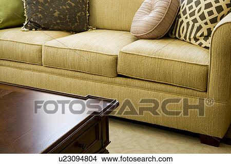 Picture - Detail green sofa and corner of coffee table. Fotosearch
