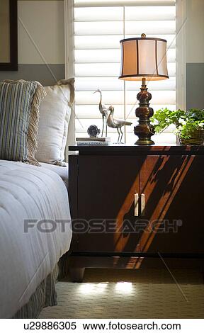 Detail of a neatly made bed next to an end table View Large Photo Image Stock Photography - Detail of a neatly made bed next to an end table. Fotosearch