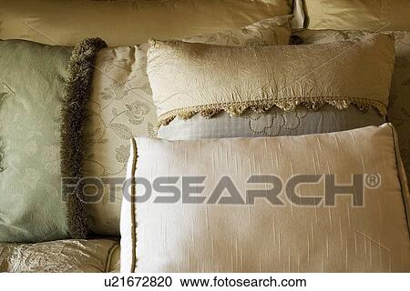 Stock Image - Detail of decorative pillows on bed. Fotosearch