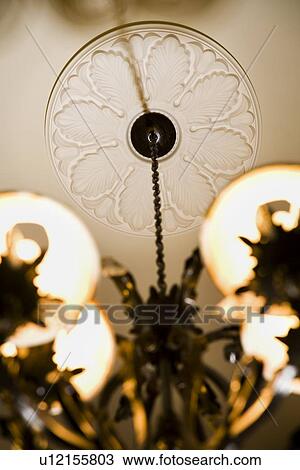 Stock Image - Detail of molding supporting chandelier. Fotosearch