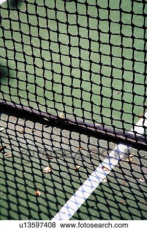 Stock Photo - Detail of net and shadow on tennis court. Fotosearch