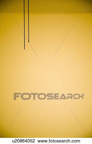 Stock Image - Detail of pull chains from ceiling fan. Fotosearch