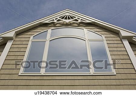 Picture - Detail of shingle style house with large picture window. Fotosearch