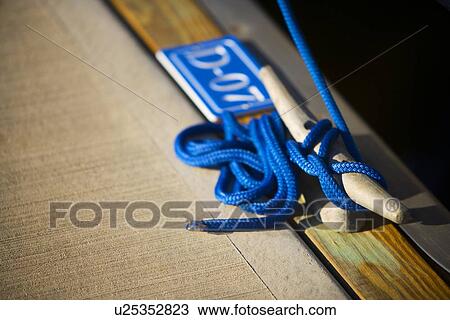 Detail of tied rope docking boat View Large Photo Image Stock Image - Detail of tied rope docking boat. Fotosearch
