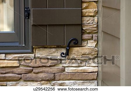Detail of wooden shutter against stone facade View Large Photo Image Stock Photograph - Detail of wooden shutter against stone facade. Fotosearch