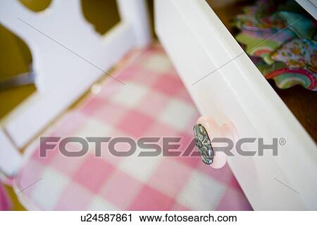 Detail pink drawer knob over pink gingham chair cushion View Large Photo Image Stock Image - Detail pink drawer knob over pink gingham chair cushion. Fotosearch