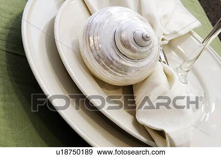 Stock Photo - Detail place setting with decorative shell. Fotosearch