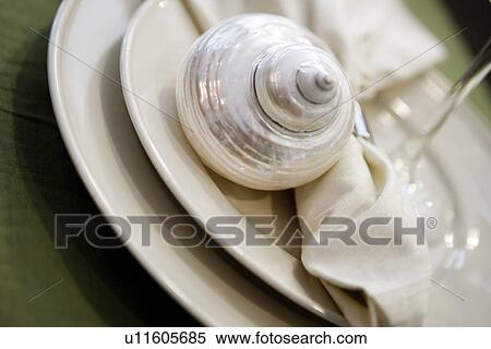 Stock Photography - Detail place setting with decorative shell. Fotosearch