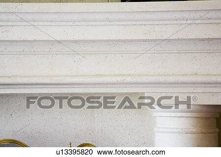 Stock Image - Detail stone facade of fireplace and mantle. Fotosearch