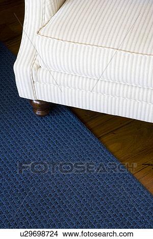 Detail striped armchair on blue area rug View Large Photo Image Picture - Detail striped armchair on blue area rug. Fotosearch