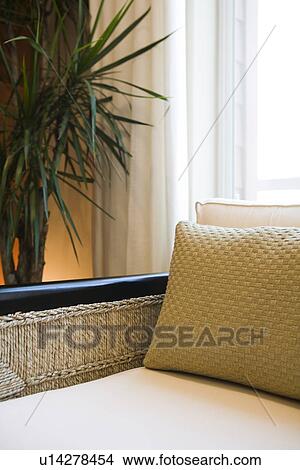 Picture - Detail wicker armchair in front of window. Fotosearch