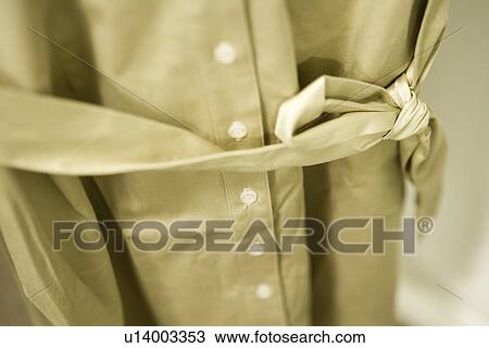 Stock Image - Detail woman's button down green dress. Fotosearch