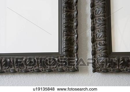 Stock Photo - Detail wooden picture frames on wall. Fotosearch