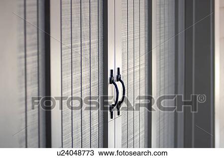 Stock Image - Detail wooden shed doors and handles. Fotosearch