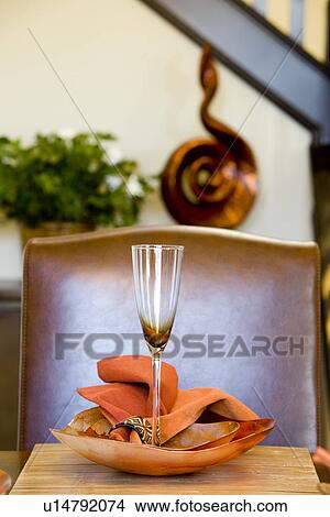 Picture - Dining table with orange place setting. Fotosearch