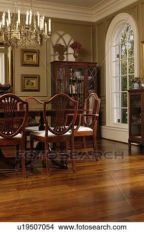 Elegant dining room with oak hardwood floors and Hepplewhite style dining chairs View Large Photo Image Picture - Elegant dining room with oak hardwood floors and Hepplewhite style dining chairs. Fotosearch
