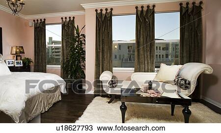 Stock Image - Elegant master bedroom with chaise lounge. Fotosearch