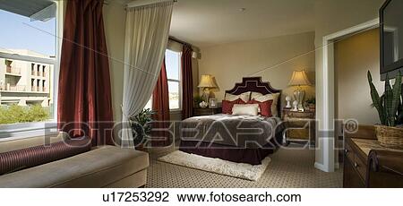 Elegant Master Bedroom With Red Accents Stock Image