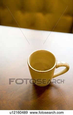 Empty coffee mug on wooden dining table View Large Photo Image Stock Photo - Empty coffee mug on wooden dining table. Fotosearch