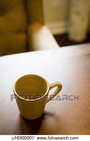 Empty coffee mug on wooden dining table View Large Photo Image Stock Photo - Empty coffee mug on wooden dining table. Fotosearch
