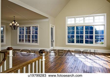 Stock Image - Empty great room with hardwood floors. Fotosearch