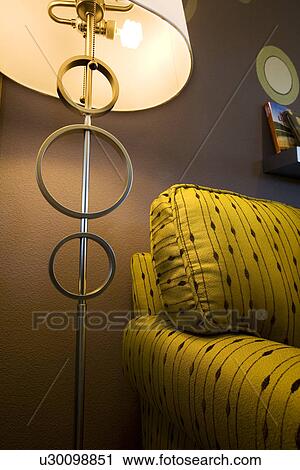 Stock Image - End of retro print sofa and floor lamp. Fotosearch