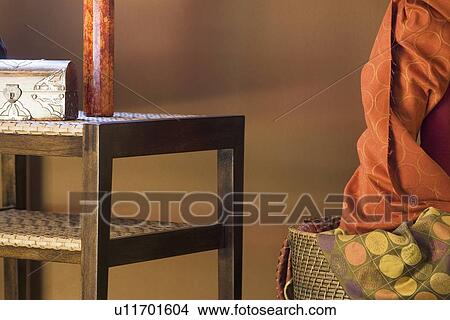 Picture - End table with decorative chest and vase on top. Fotosearch